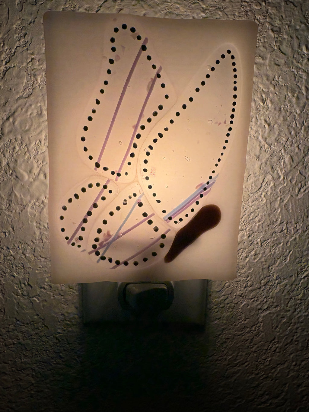 Fused glass dragonfly nightlight - unlit, showing clear background with black dot wing detail and lavender stringers